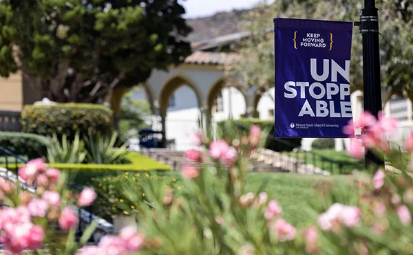 A close-up of flowers with an MSMU banner flag in the background.