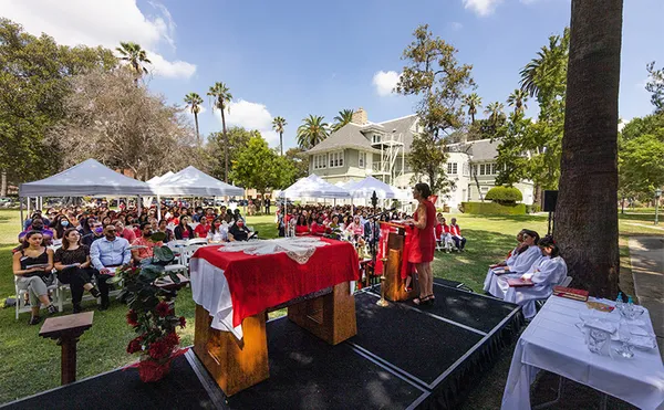 A large group of people sitting in chairs seen from a stage.