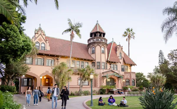 A shot of the Doheny mansion with students walking around.