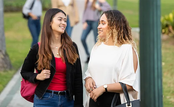 Two students walking on campus