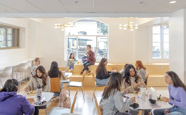 A student making a salad at a buffet