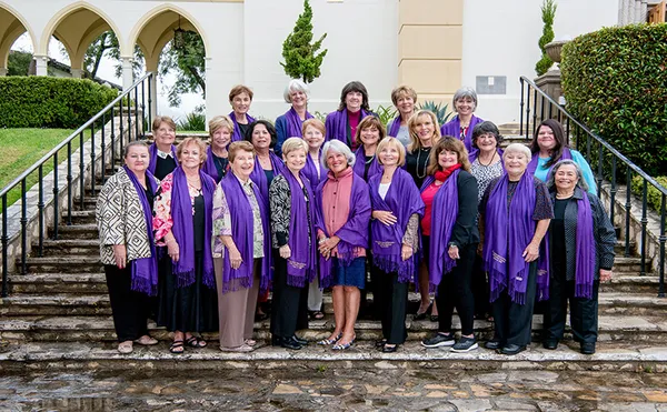 A large group of MSMU Alumnae posing for a photo on some stairs.