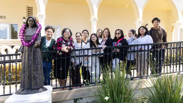 Mount students, MSMU President Ann McElaney-Johnson (seventh from left) and Shannon Green, director of the CSJ Institute (second from left), next to the statue of Mother St. John Fontbonne.