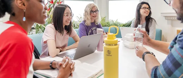 Students talking around a table