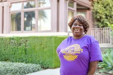 woman wearing a MSMU purple shirt smiling standing outdoors on the doheny campus