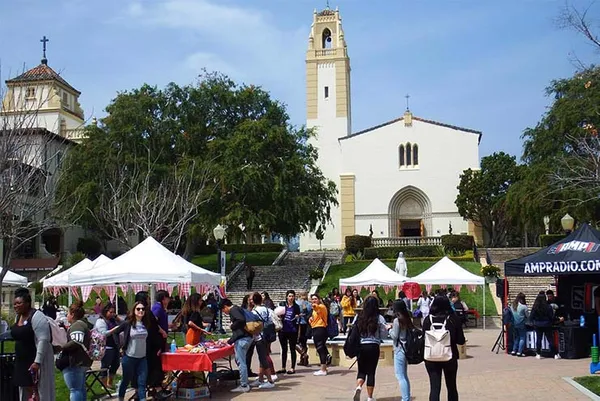 students walking around at event on campus