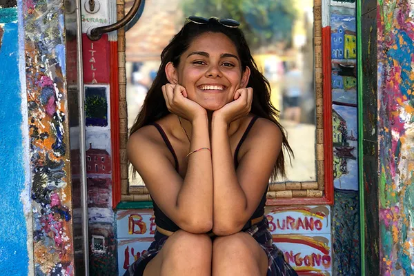 A student sitting on a step outdoors