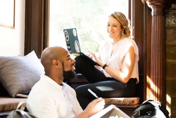 two graduate students sitting discussing