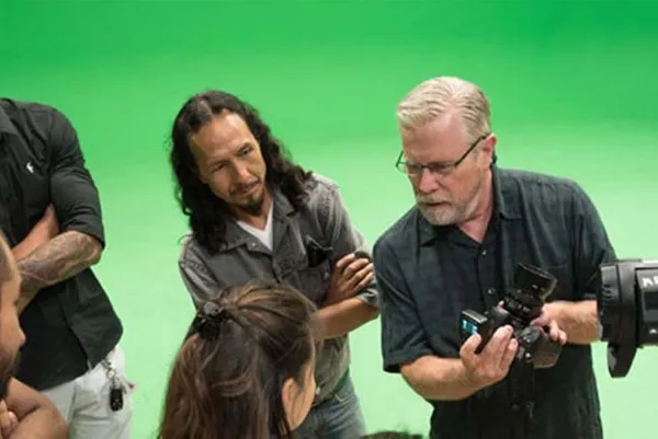 students working with professor with camera
