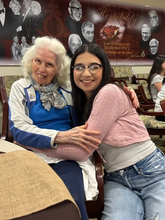 Sister Teresita Espinosa and Mount student Gianna Gutierrez share a warm embrace during the Harvest of Hearts celebration.