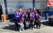 A group photo of students standing in front of the LA Society of St. Vincent de Paul.