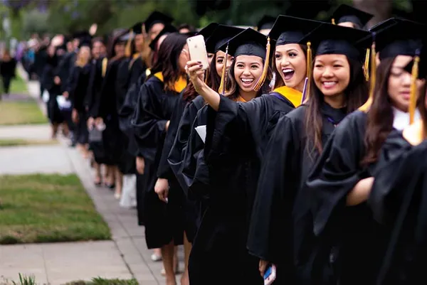 students at commencement taking a selfie