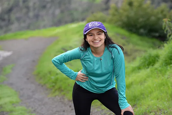 female student smiling outdoors on a walk